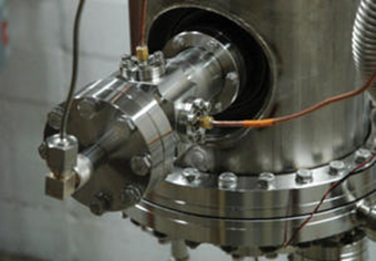 A beam position monitor supplied by Fermi National Accelerator Laboratory is mounted to an 80.5 MHz superconducting quarter-wave resonator for testing.