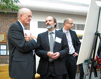 Dr. William F. Brinkman (left), the Director of the DOE Office of Science, speaks to FRIB Chief Scientist Brad Sherrill (center).