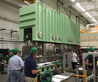 FRIB Cryomodule Department employees test fit the vacuum vessel on the first production cryomodule.