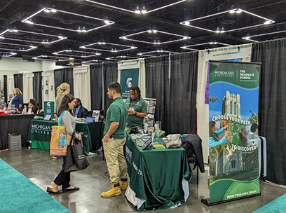 Participants of the 2023 National Diversity in STEM Conference (NDiSTEM) visit the FRIB booth during the NDiSTEM graduate school and career expo.