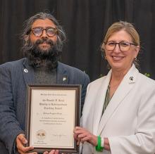 Jaideep Taggart Singh (second from left), receives his Donald F. Koch Quality in Undergraduate Teaching Award from MSU Interim President Teresa Woodruff (second from right).