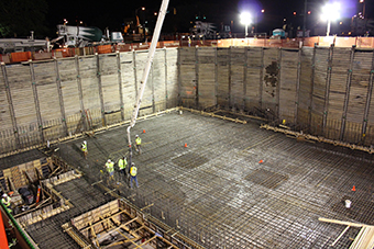 Workers place 1,400 cubic yards of concrete for the linear accelerator tunnel. 