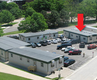 The newest construction trailer (indicated with arrow) provides more office and meeting space as the Conventional Facilities Division prepares for final design of civil construction.